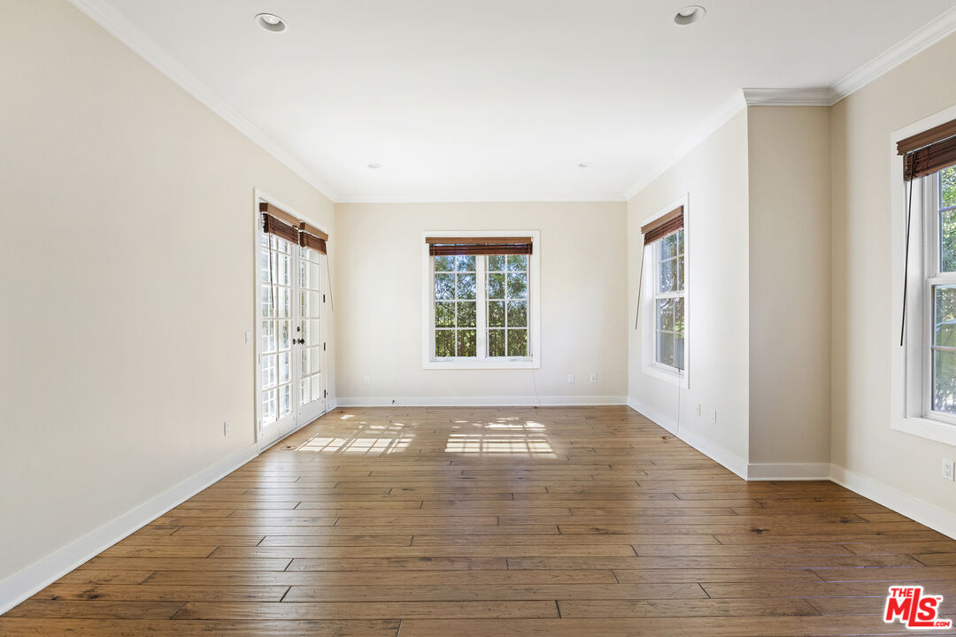 28930 Hampton Place Malibu, CA 90265 - Photo 6 of 55 a view of an empty room with wooden floor and a window