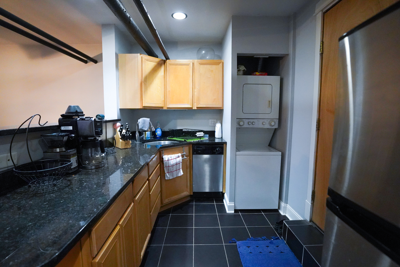 4402 North Malden Street, Unit G Chicago, IL 60640 - Photo 4 of 16 a kitchen with kitchen island granite countertop a sink appliances cabinets and a counter top space