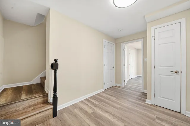 a view of a room with wooden floor