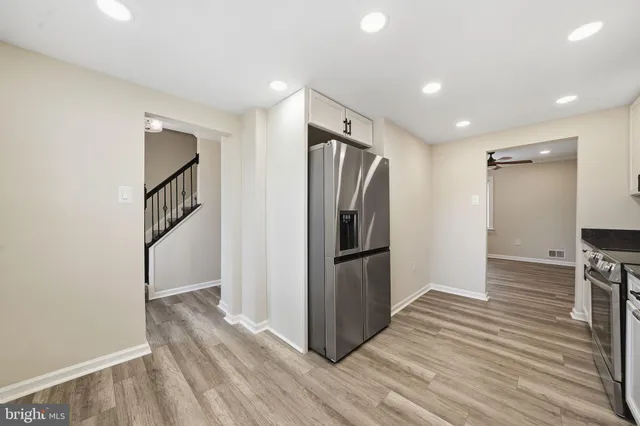 a view of a kitchen with wooden floor and electronic appliances