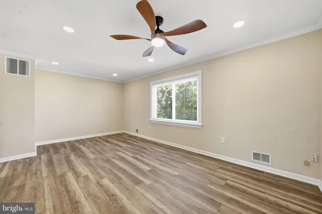 wooden floor in an empty room with a window