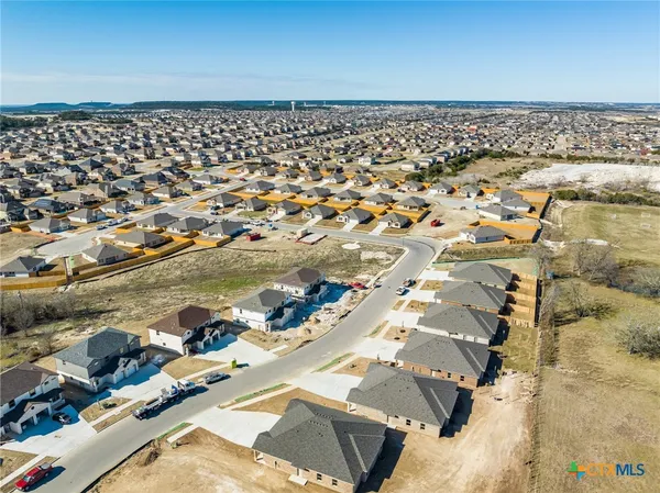 an aerial view of ocean with residential house with outdoor space