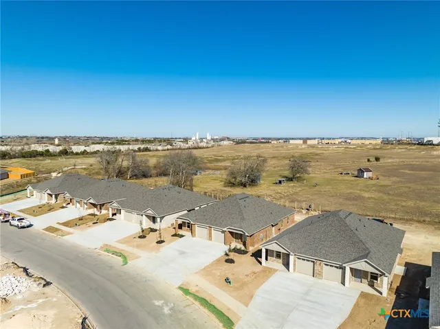 an aerial view of residential building and ocean