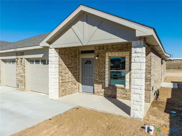 a front view of a house with glass windows and door