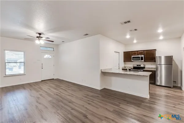 a view of kitchen with sink microwave and stove
