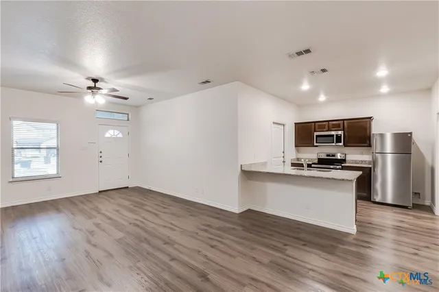 a view of kitchen with sink microwave and stove