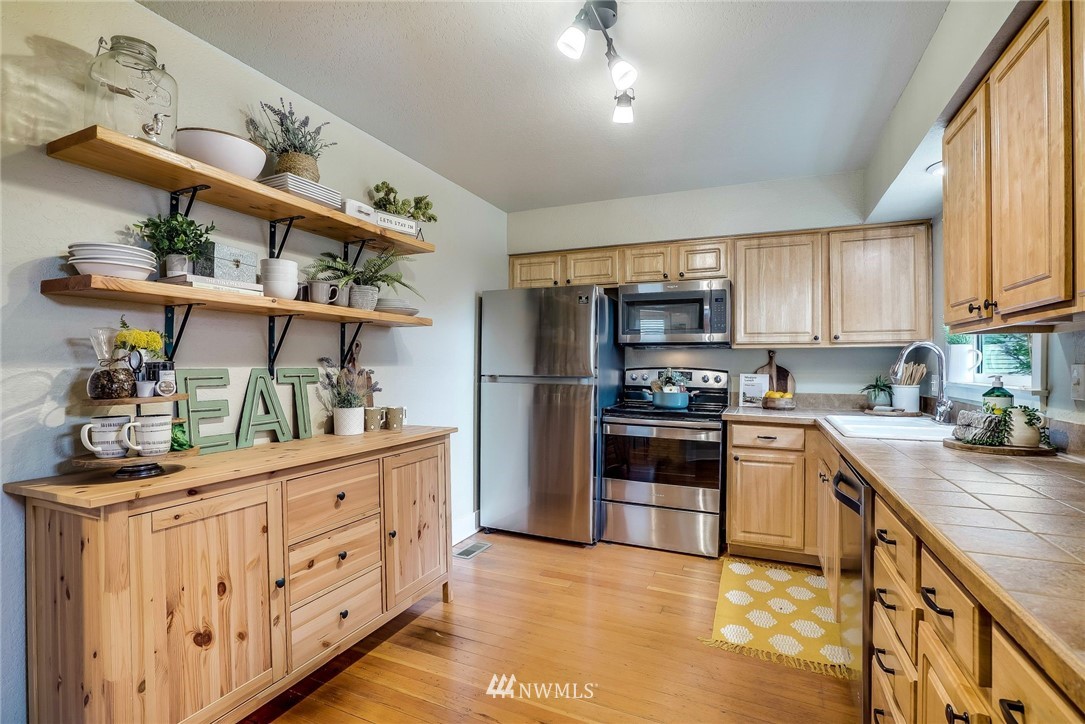 2309 Baker Avenue Everett, WA 98201 - Photo 11 of 26 a kitchen with stainless steel appliances granite countertop a refrigerator and a stove top oven