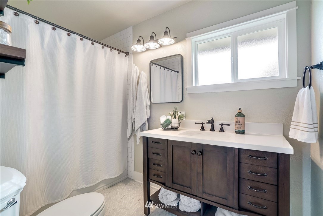 2309 Baker Avenue Everett, WA 98201 - Photo 13 of 26 a bathroom with a sink a toilet and a mirror