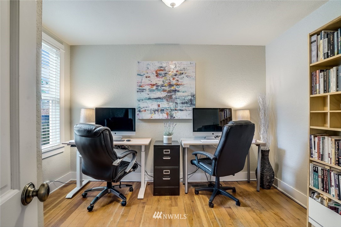 2309 Baker Avenue Everett, WA 98201 - Photo 17 of 26 a view of a workspace with furniture and a bookshelf