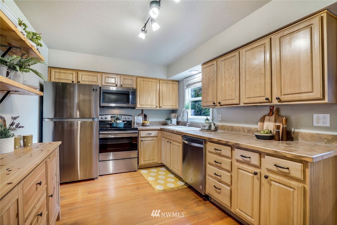 2309 Baker Avenue Everett, WA 98201 - Photo 10 of 26 a kitchen with stainless steel appliances granite countertop a refrigerator stove microwave and sink