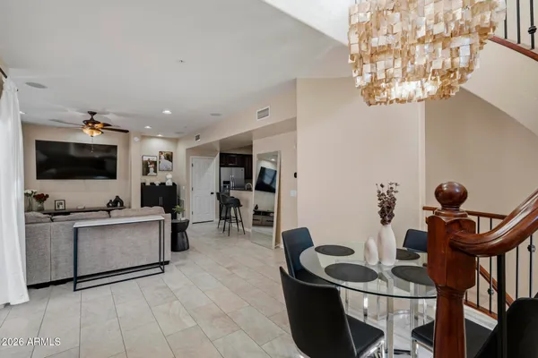 a living room with furniture a flat screen tv and kitchen view