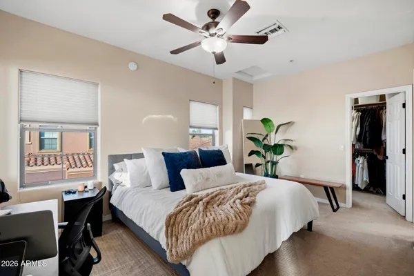 a bedroom with a bed and a chandelier