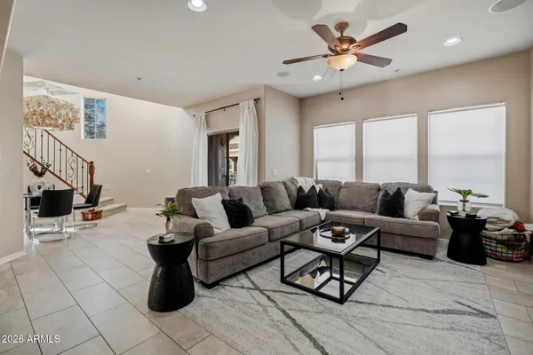 a living room with furniture a flat screen tv and a window