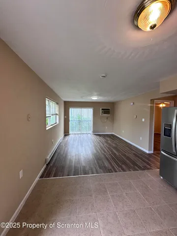 a view of a room with wooden floor and staircase
