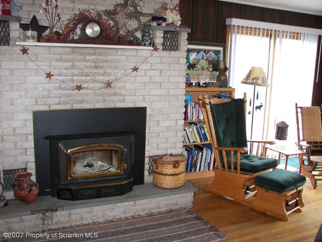 2 Rr Union Dale, PA 18470 - Photo 12 of 15 a living room with furniture a fireplace and a floor to ceiling window