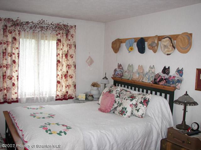 2 Rr Union Dale, PA 18470 - Photo 13 of 15 a bedroom with a bed and a window