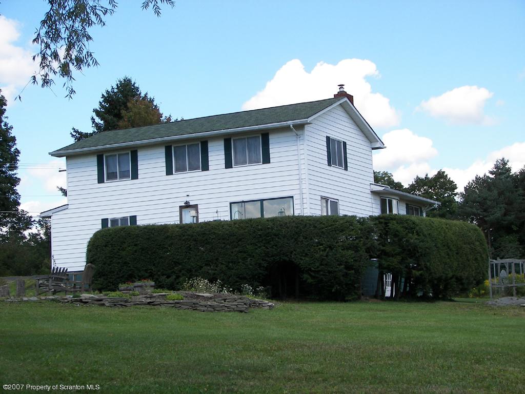 2 Rr Union Dale, PA 18470 - Photo 2 of 15 a front view of a house with a garden