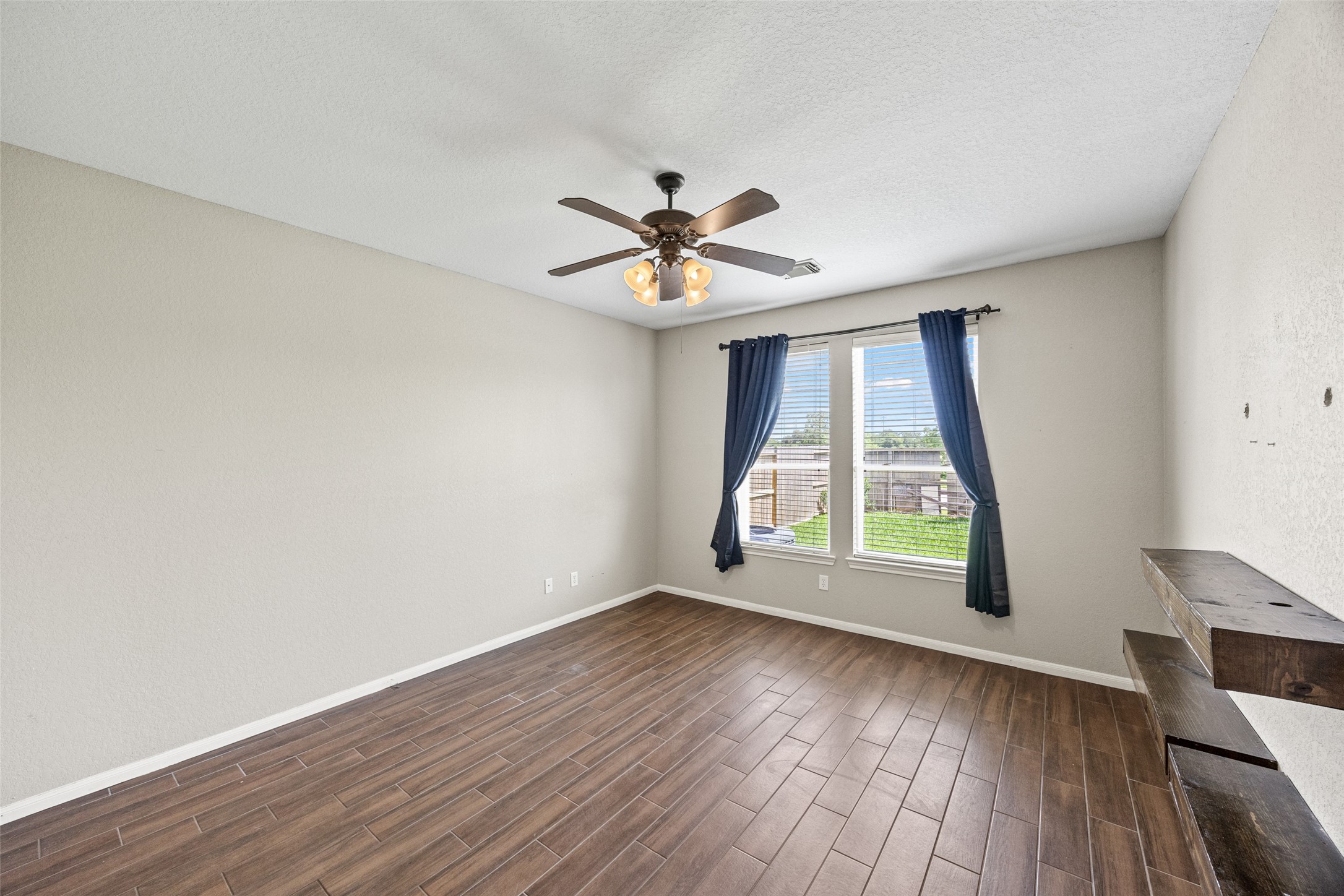 6014 Flagg Ranch Court Spring, TX 77388 - Photo 13 of 23 an empty room with wooden floor and windows