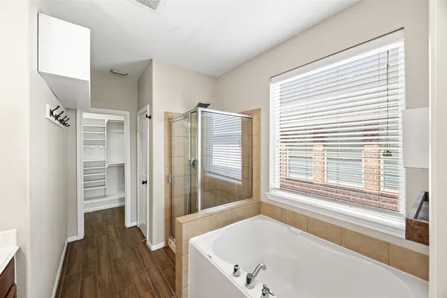 a bathroom with a tub and a window