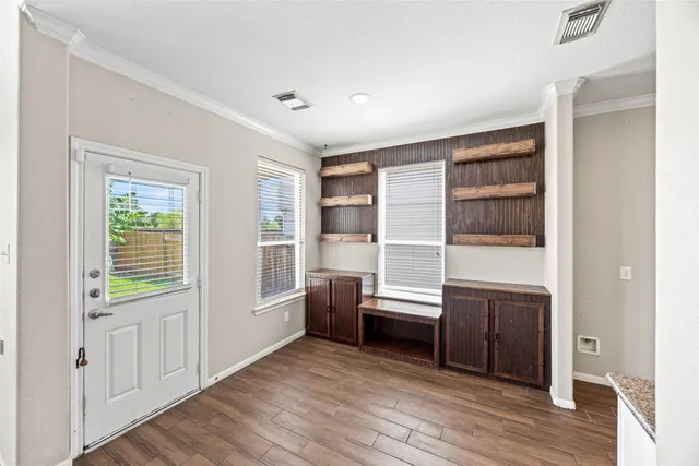 a view of wooden floor and windows in a room