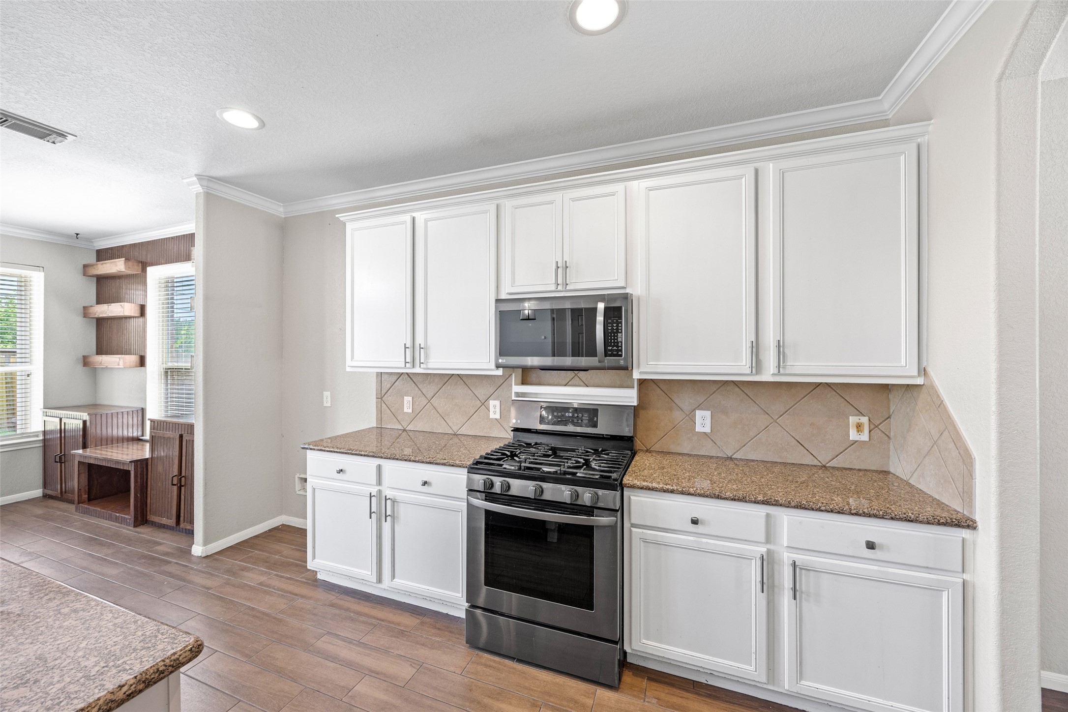 6014 Flagg Ranch Court Spring, TX 77388 - Photo 9 of 23 a kitchen with stainless steel appliances white cabinets and a stove top oven