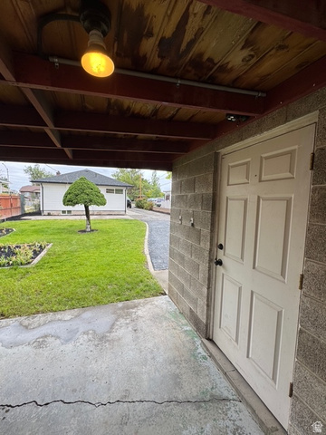 189 West Center Street Midvale, UT 84047 - Photo 49 of 64 Covered concrete patio with overhead lighting and a paneled entry door