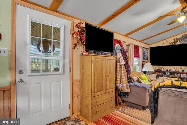 a view of a living room with furniture and a flat screen tv