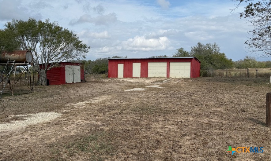 4689 County Road 302 Runge, TX 78151 - Photo 3 of 40 a front view of a house with a yard and garage