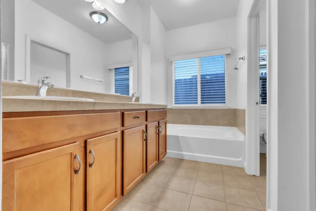 a bathroom with a bathtub and a window