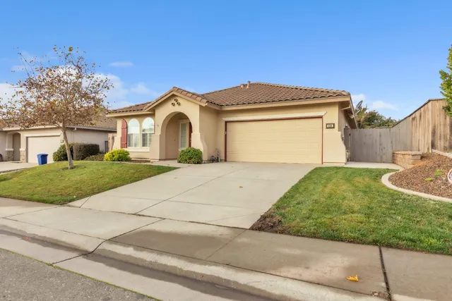 a front view of a house with a yard and garage