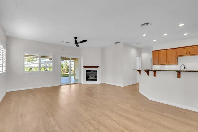 a kitchen with granite countertop a sink and a refrigerator