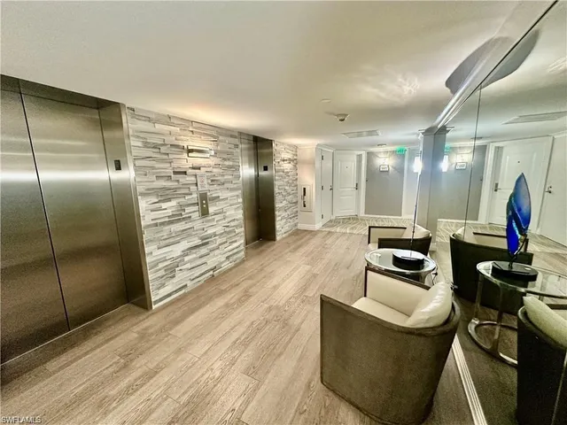 a lobby with furniture and a wooden floor