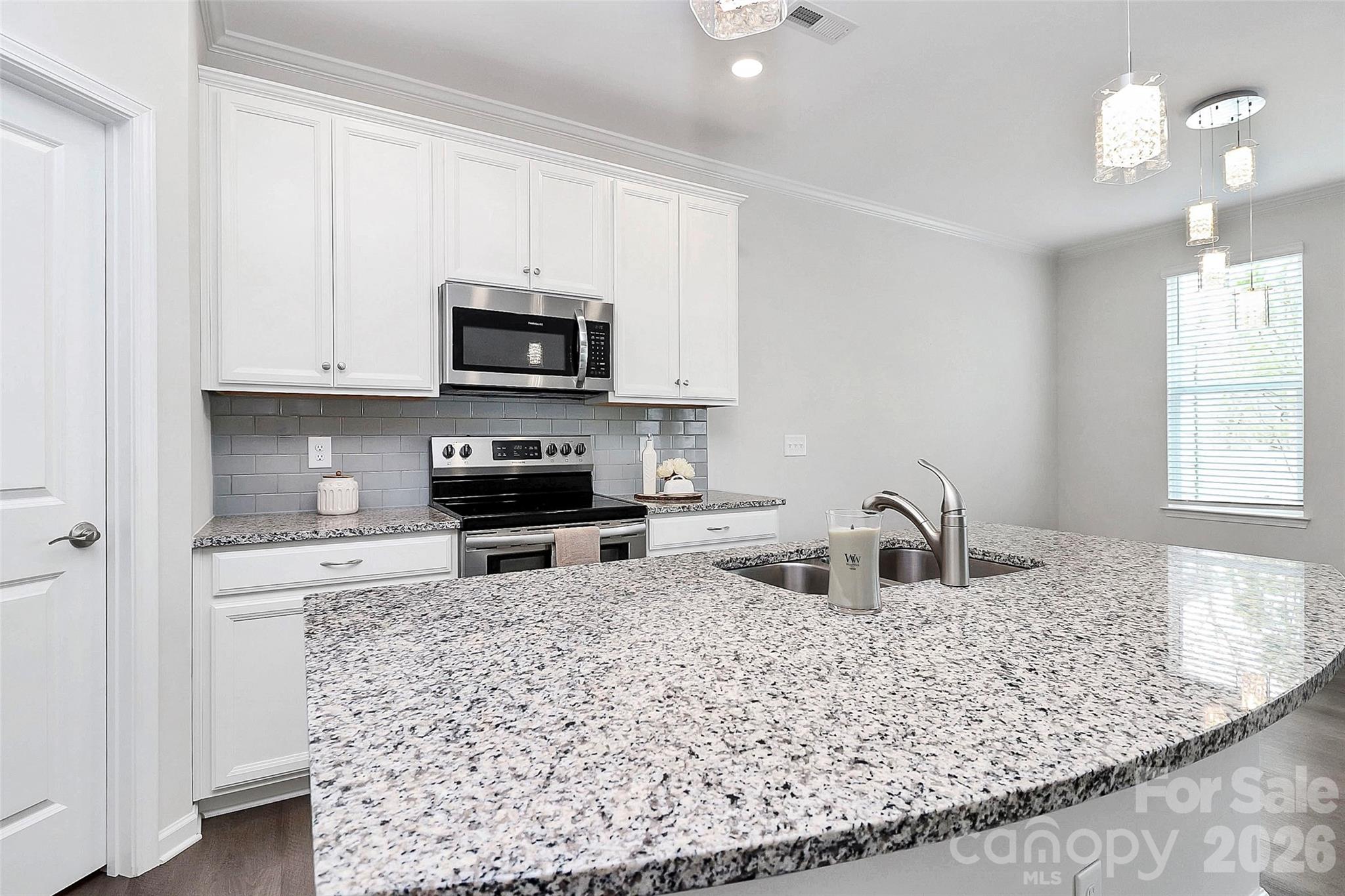 769 River Park Road Belmont, NC 28012 - Photo 14 of 41 a kitchen with granite countertop a sink cabinets and stainless steel appliances