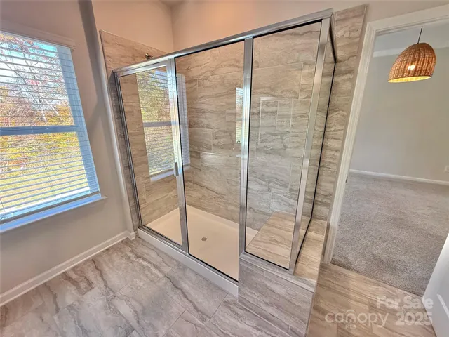 a white toilet sitting next to a white wall