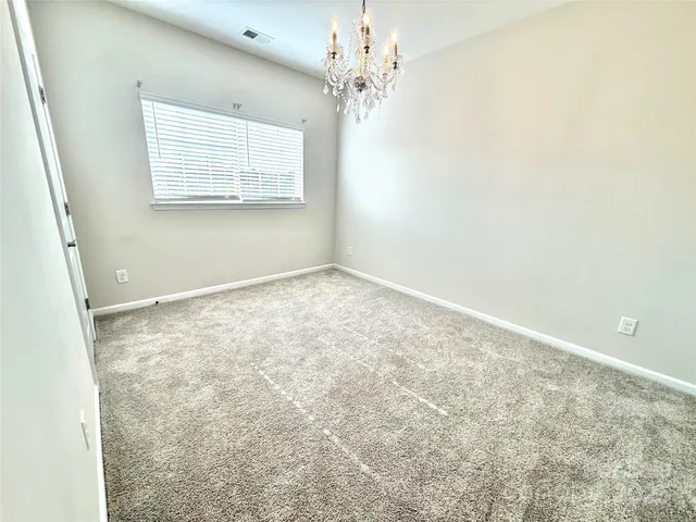 a view of a chandelier in big room and chandelier