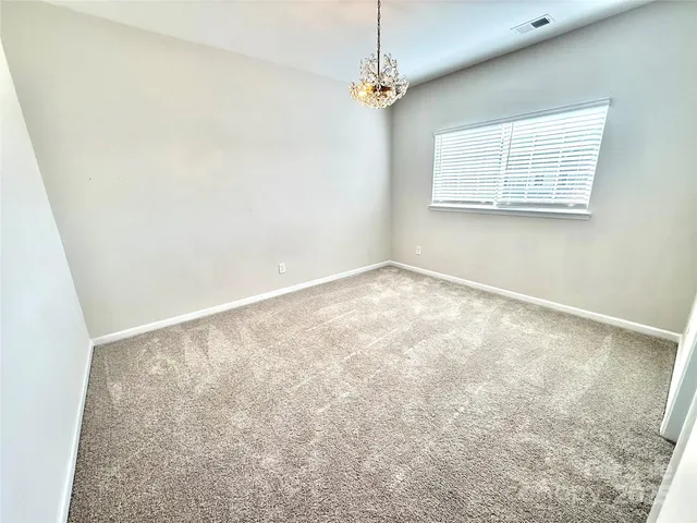 a view of an empty room with a chandelier
