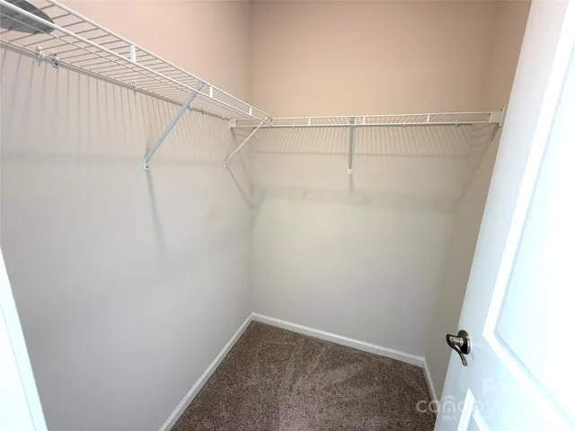 a view of a hallway to rooms