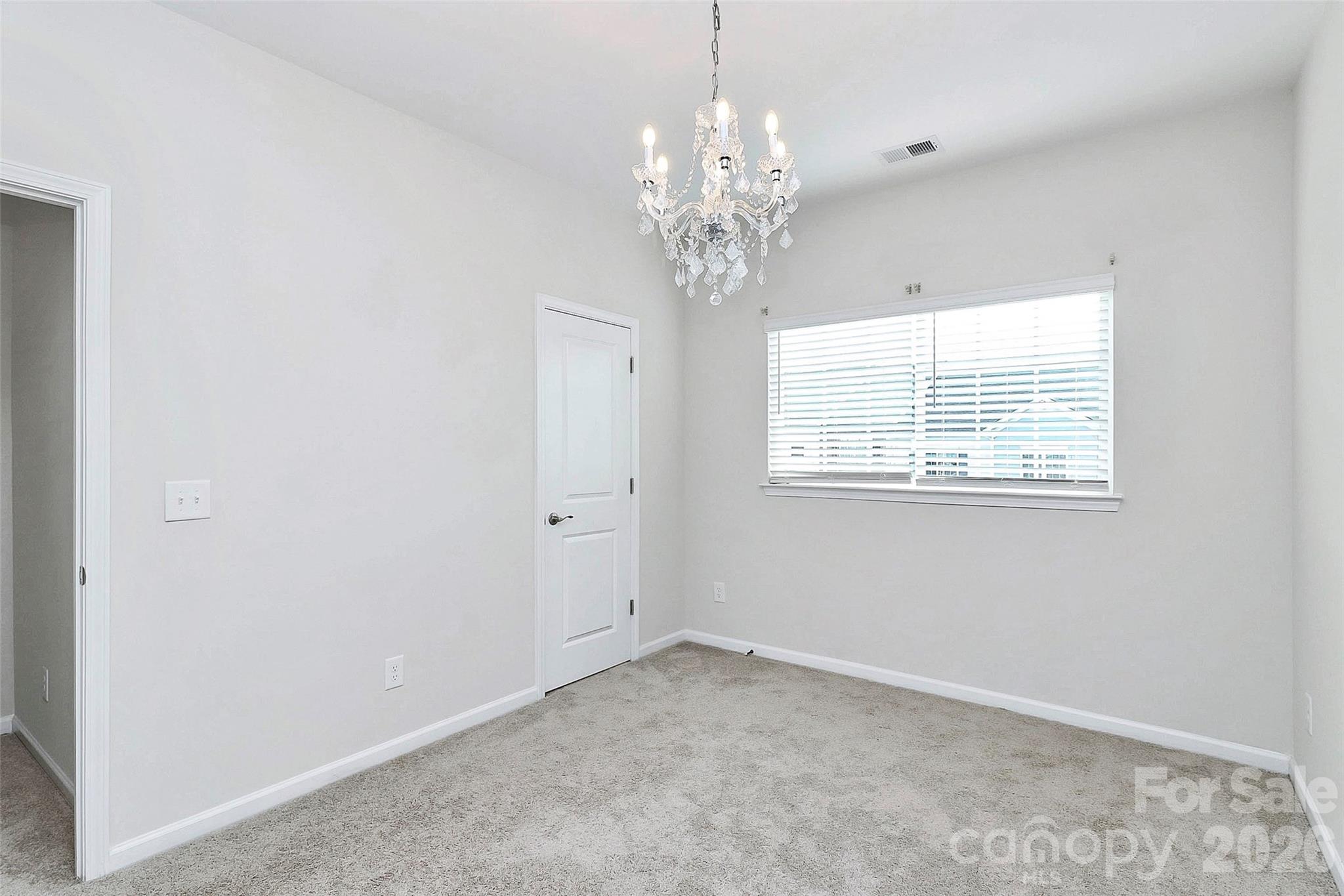 769 River Park Road Belmont, NC 28012 - Photo 31 of 41 en empty room with chandelier and window