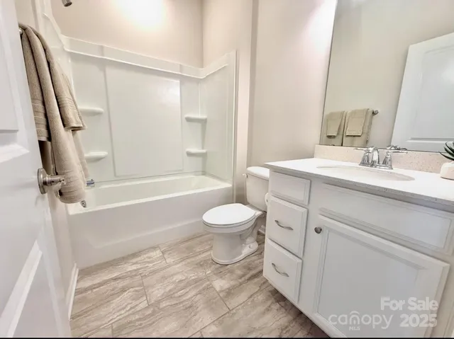 a bathroom with a toilet sink and a mirror