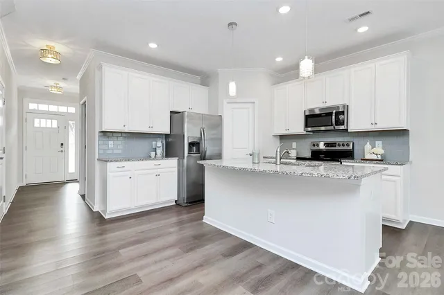 a kitchen with a sink stove and refrigerator