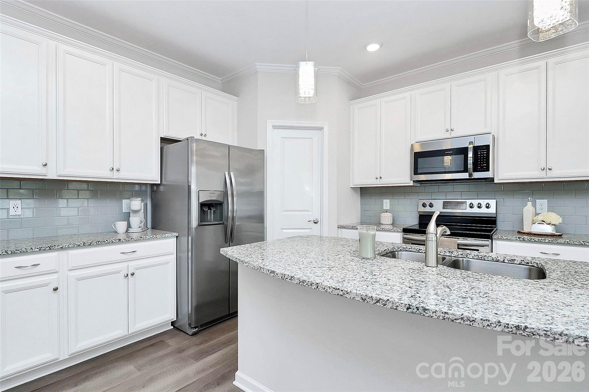 769 River Park Road Belmont, NC 28012 - Photo 10 of 41 a kitchen with stainless steel appliances granite countertop a sink a stove a refrigerator a sink and white cabinets