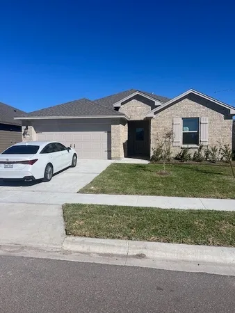 a front view of a house with a yard