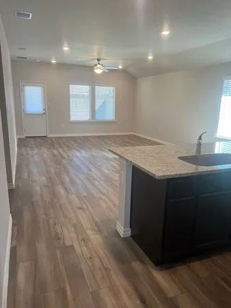 a room with wooden floor and window