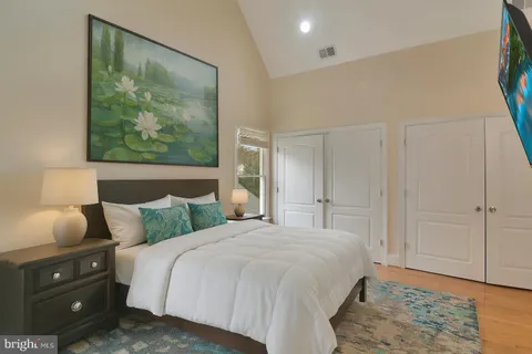 a bedroom with a bed and lamp