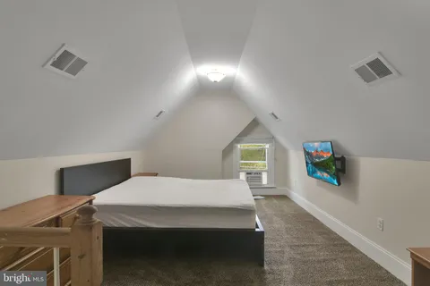 a bedroom with a bed and a night stand