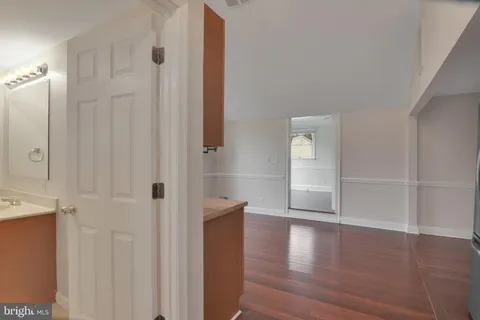 a view of empty room with window and wooden floor