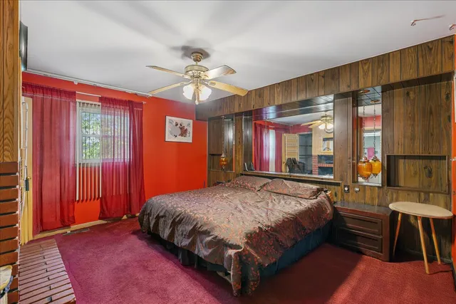 a bedroom with a bed dresser and a window