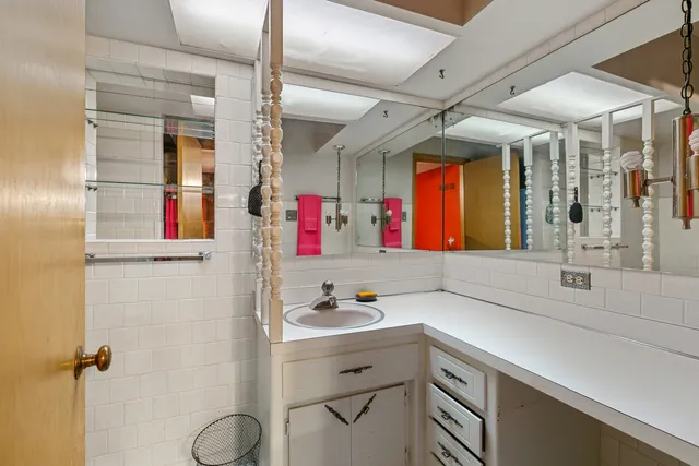 a bathroom with a sink vanity and mirror