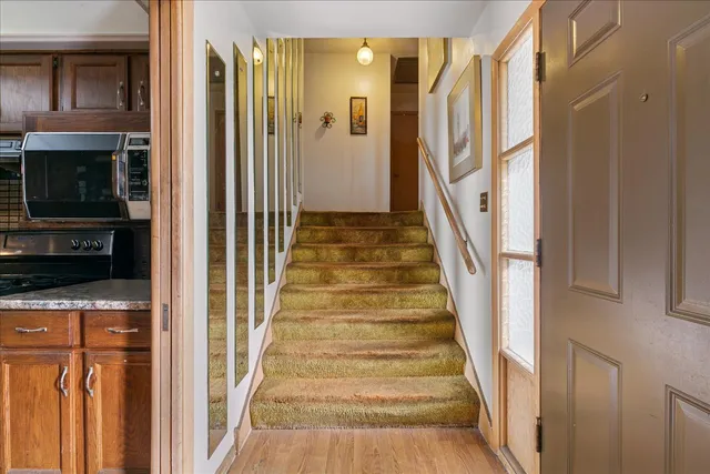 a view of an entryway with wooden floor and a front door