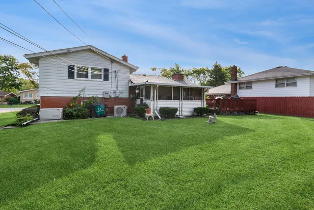 a front view of a house with a garden and plants